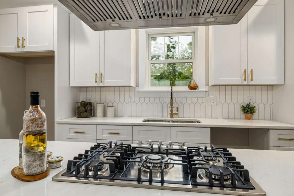 Contemporary kitchen interior showcasing a sleek gas stove and bright cabinetry, perfect for home design inspiration.